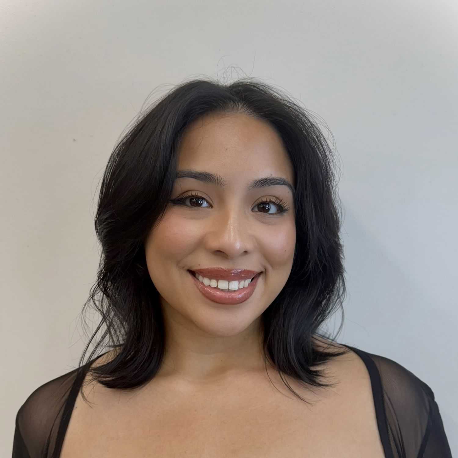 Portrait of Esme, a professional stylist at ARIA Salon, showcasing their expertise and style.