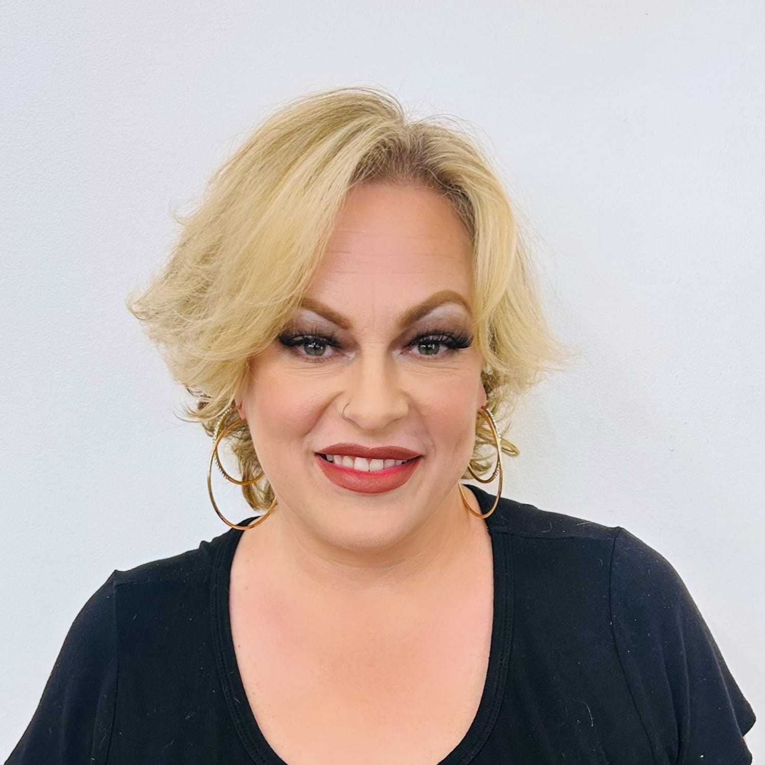 Portrait of Heather, a professional stylist at ARIA Salon, showcasing their expertise and style.