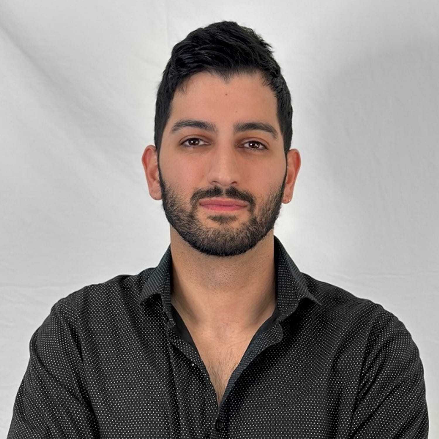 Portrait of Neima, a professional stylist at ARIA Salon, showcasing their expertise and style.