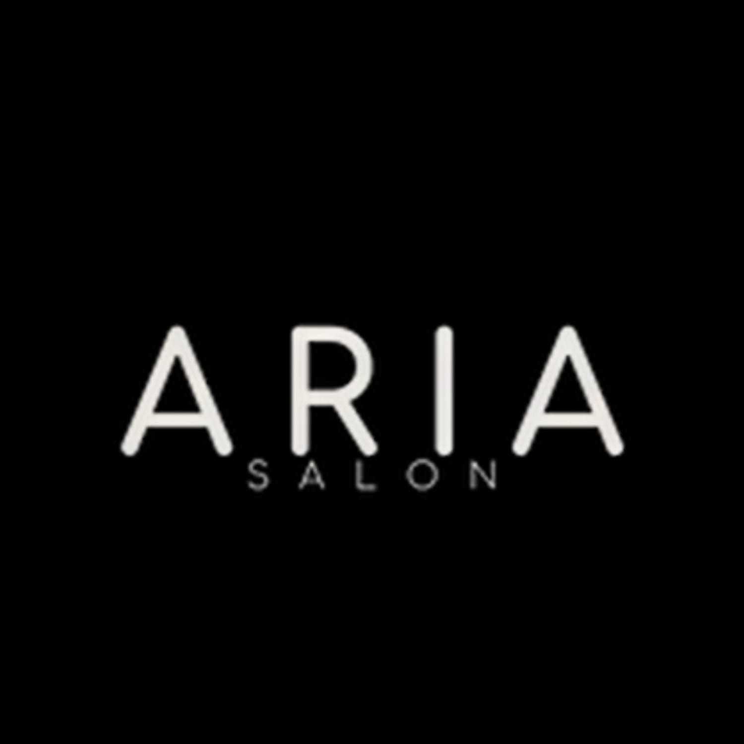 Portrait of Mechelle, a professional stylist at ARIA Salon, showcasing their expertise and style.