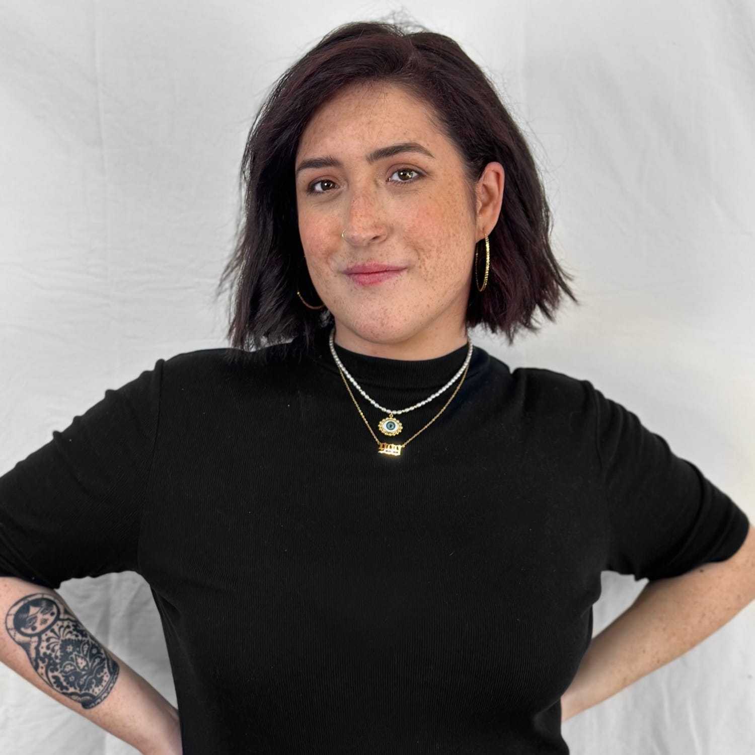 Portrait of Aria, a professional stylist at ARIA Salon, showcasing their expertise and style.