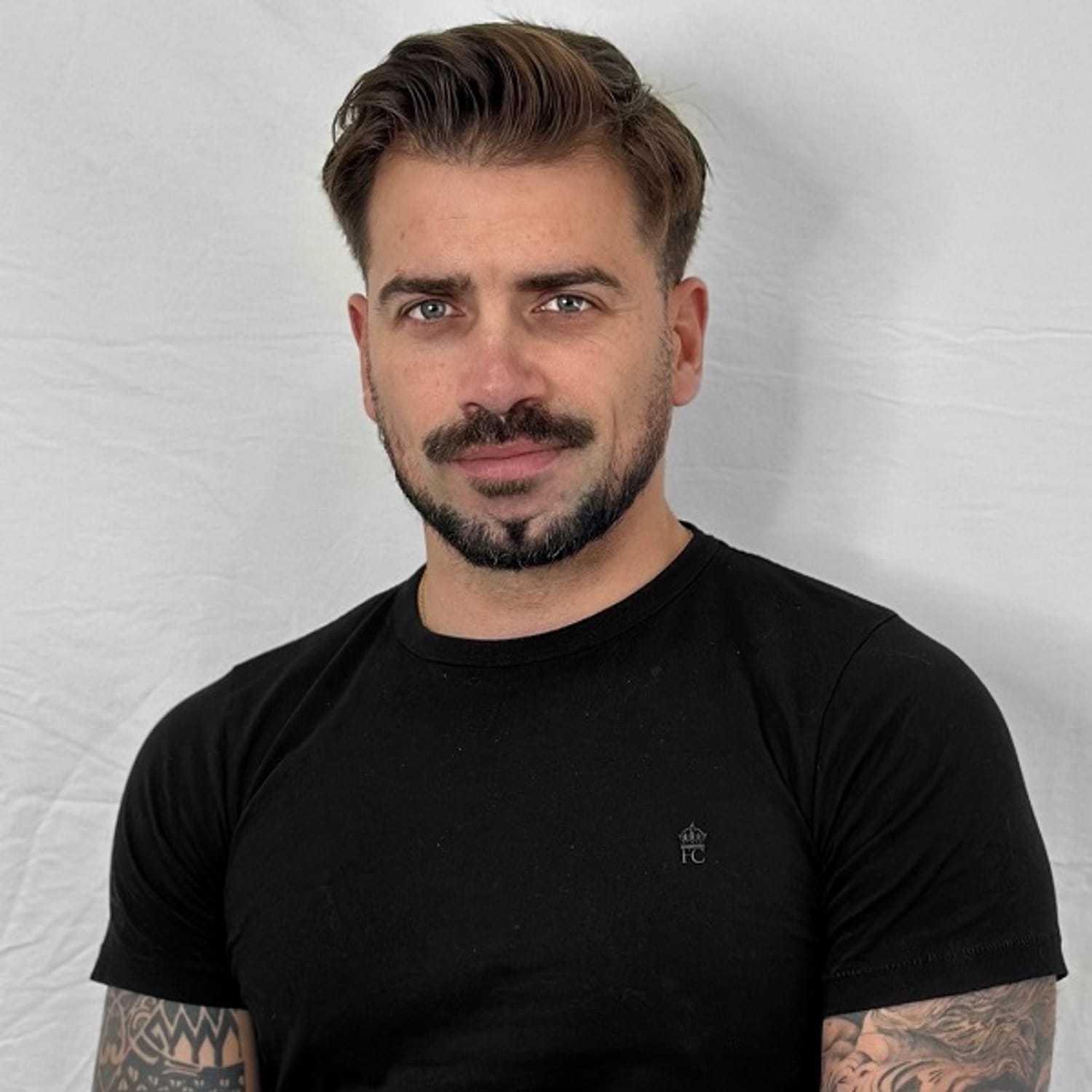 Portrait of Lluka, a professional stylist at ARIA Salon, showcasing their expertise and style.